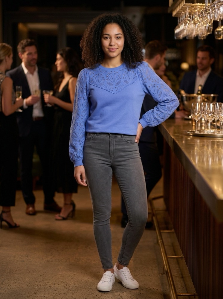 The same model and sweatshirt at an evening cocktail party